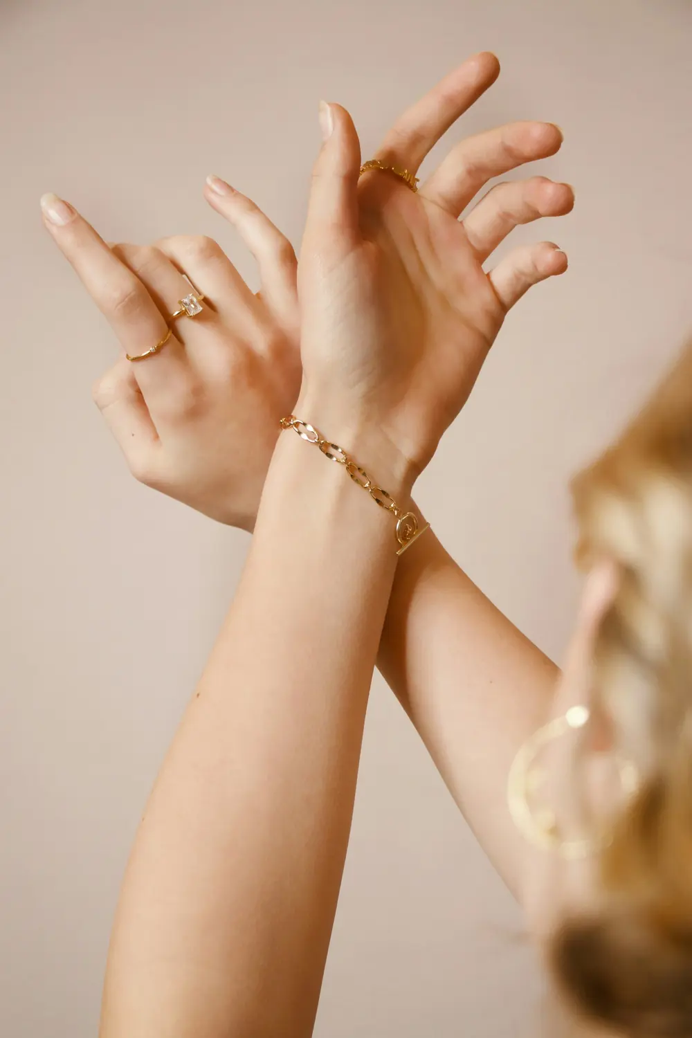 Hands wearing a diamond ring and bracelet